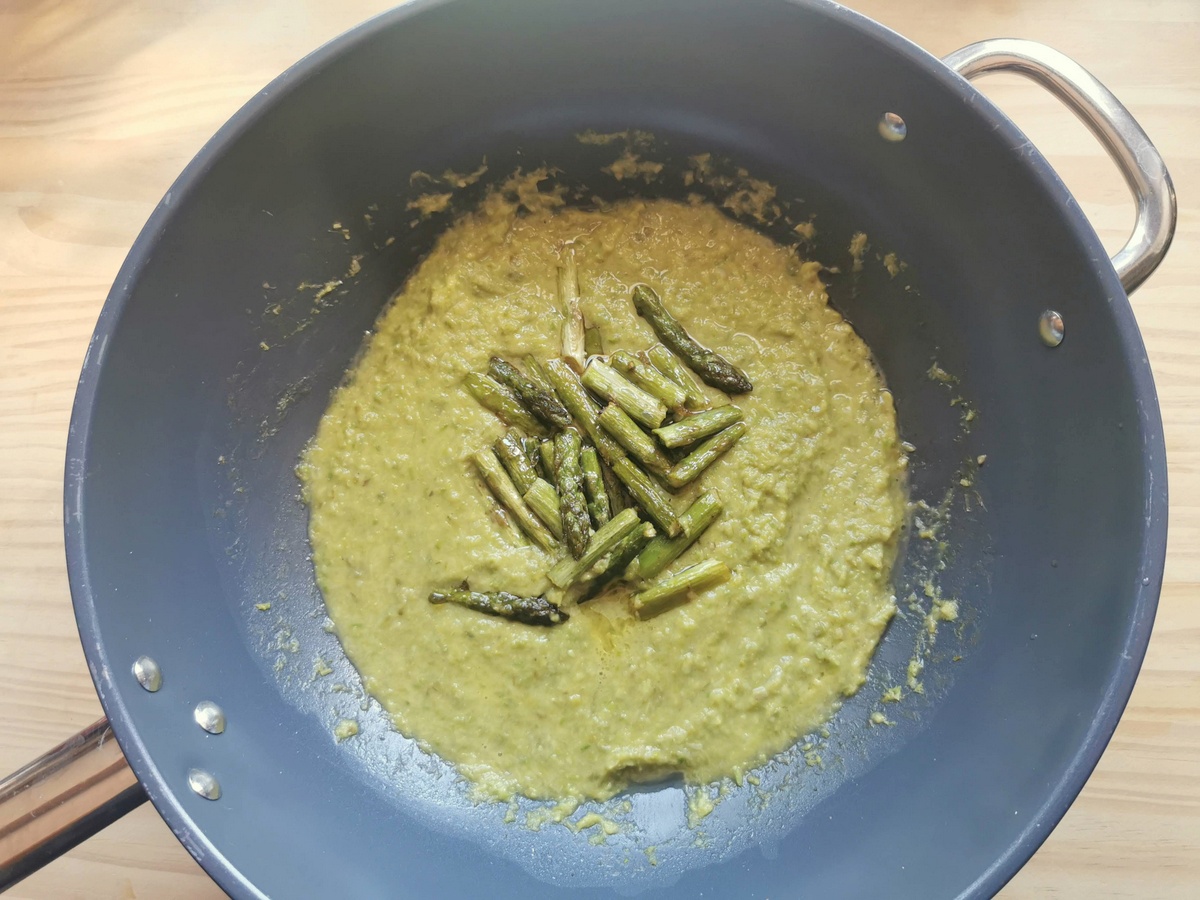 Creamy asparagus sauce with asparagus pieces in deep skillet.