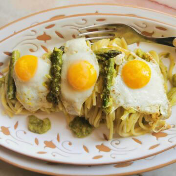 Creamy asparagus spaghetti with fried eggs.