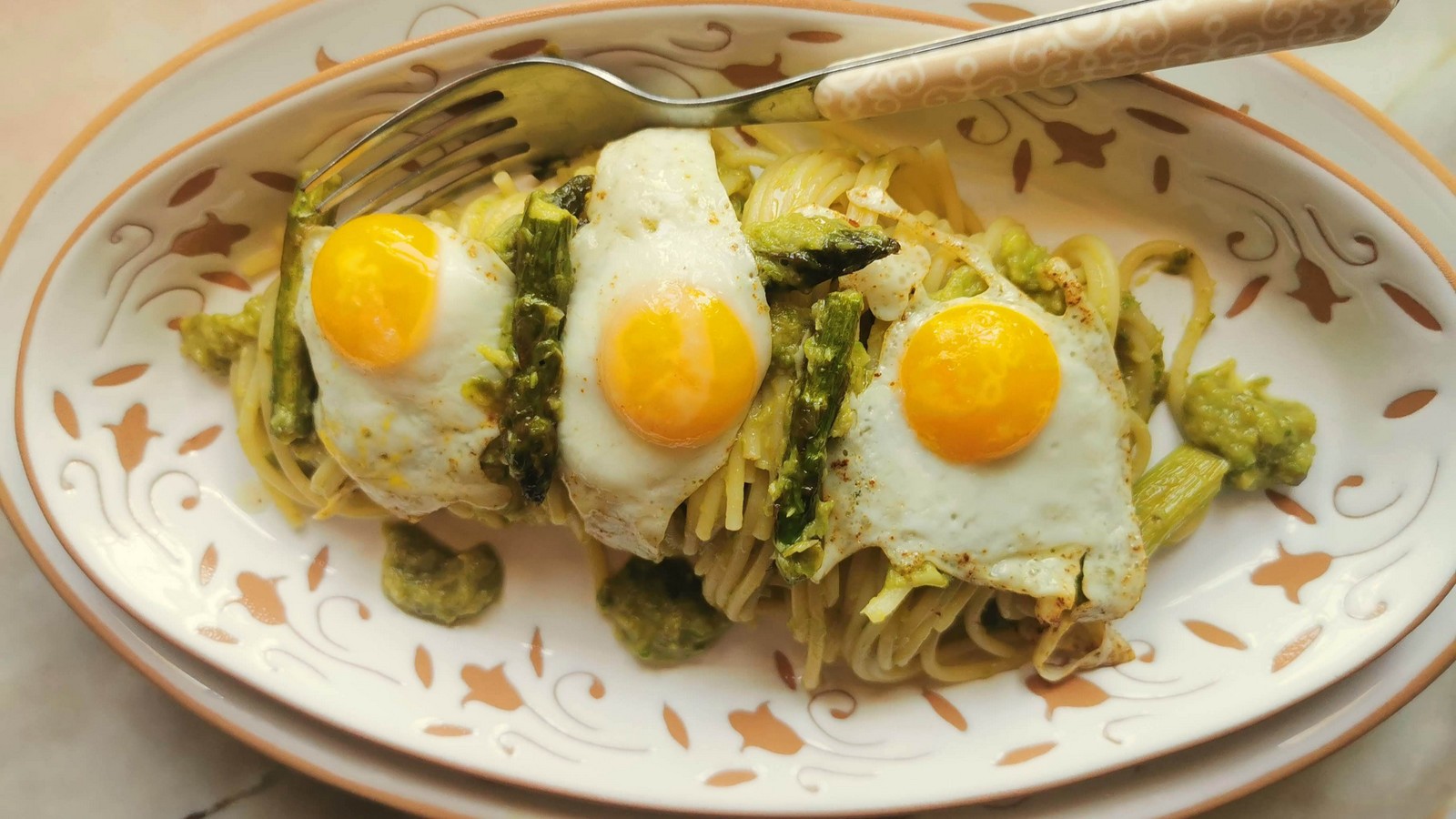 Creamy asparagus spaghetti with fried quail eggs.