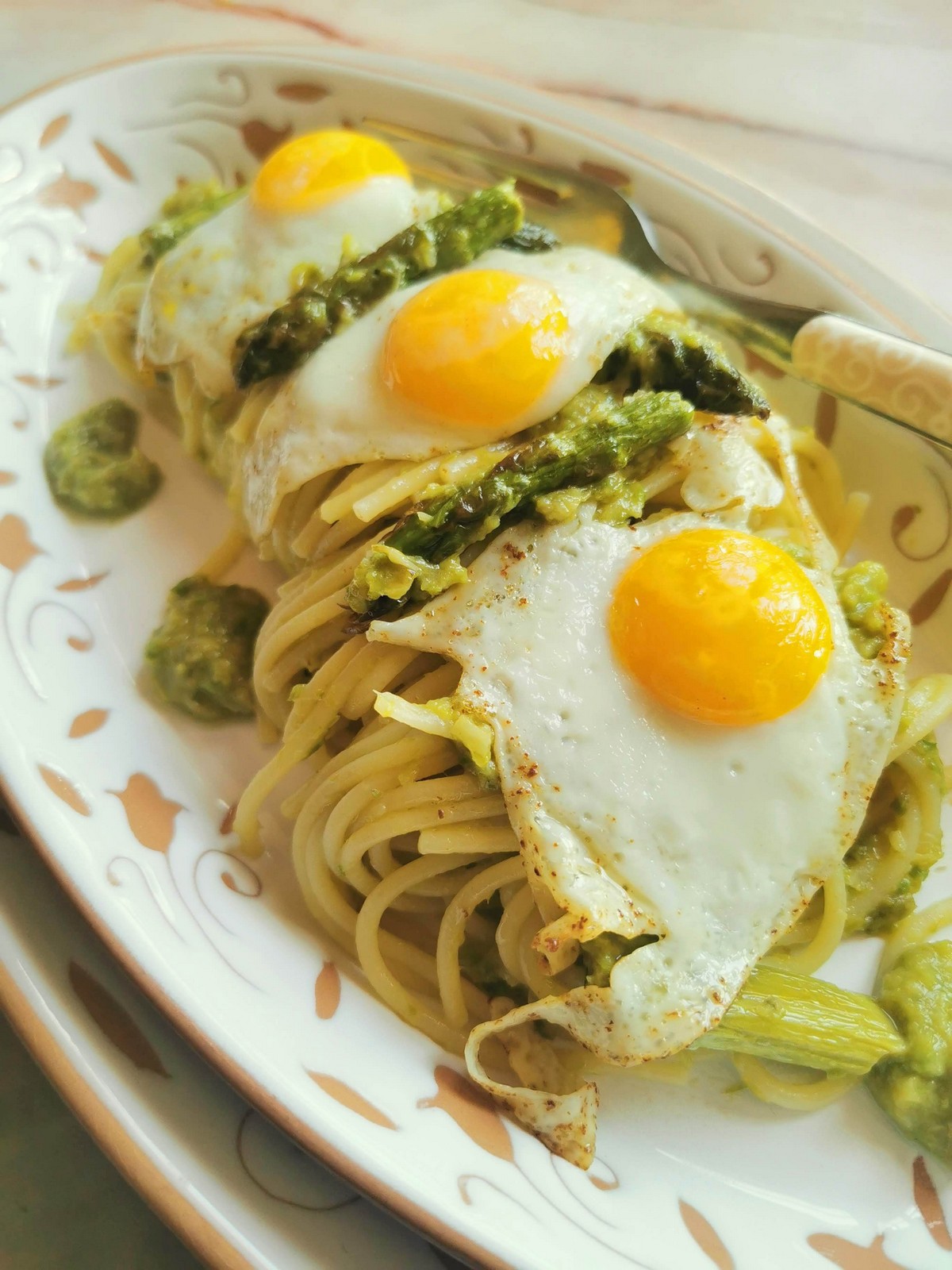 Creamy asparagus spaghetti with fried quail eggs.