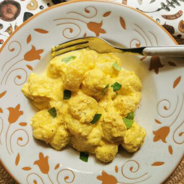 Creamy potato gnocchi with saffron sauce.