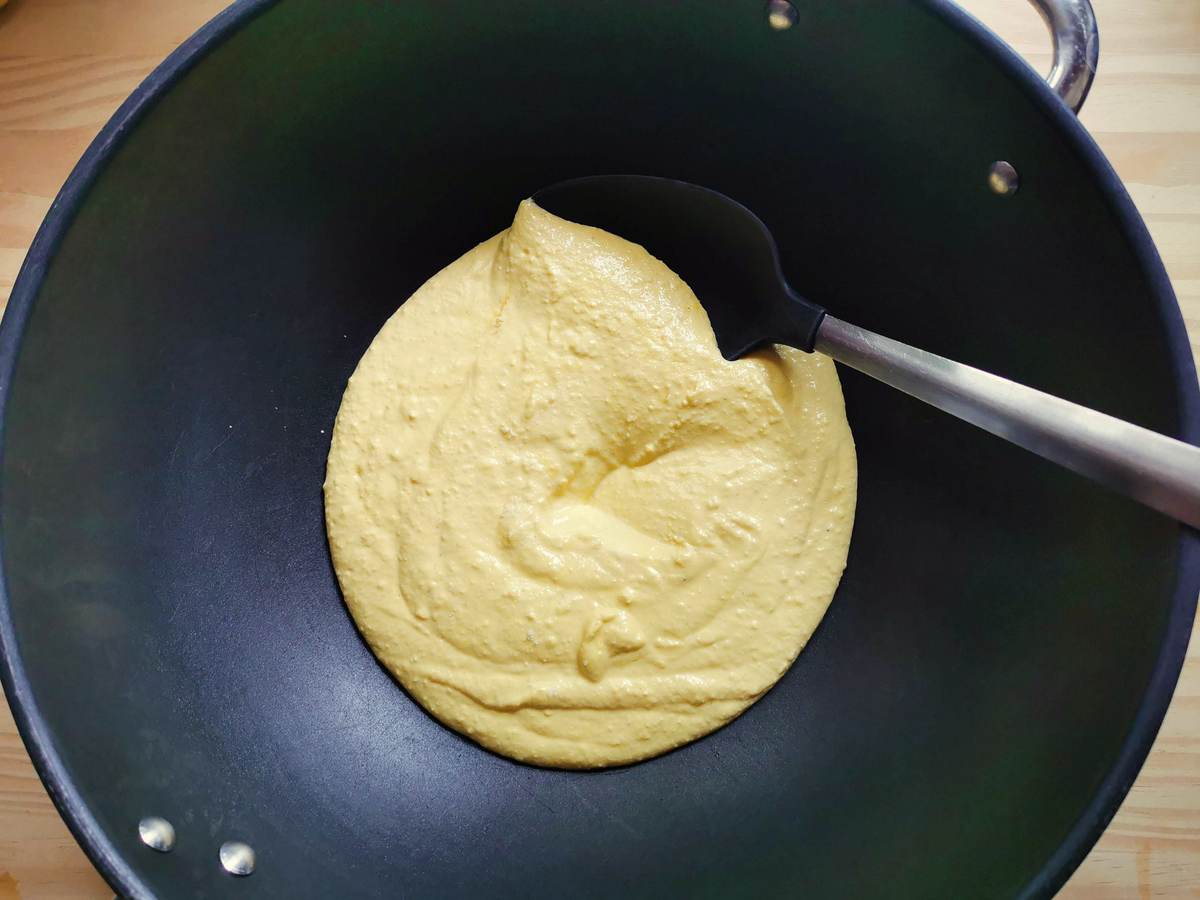 Creamy saffron sauce in deep frying pan.
