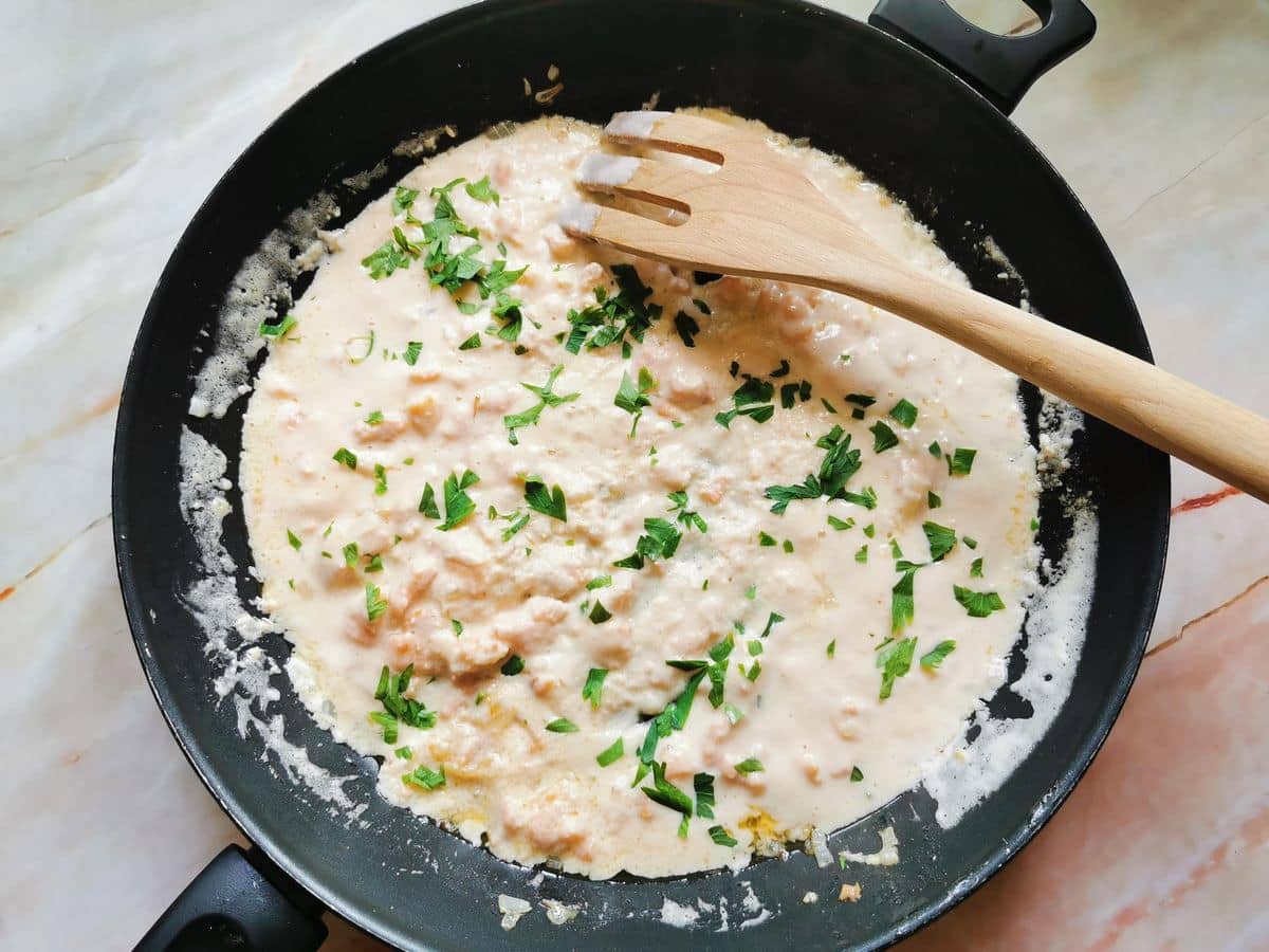 Ready creamy smoked salmon pasta sauce in skillet.