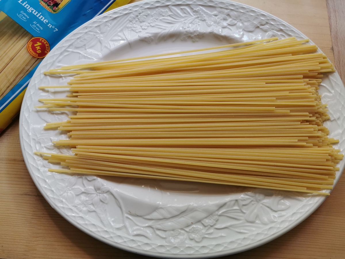 Dried linguine from DeCecco on white plate.
