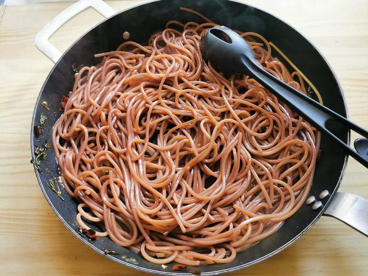 red wine pasta cooking in skillet.