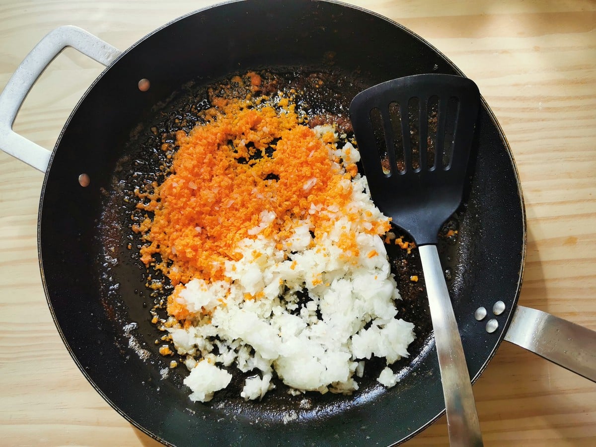 Carrots, celery and onion being softened in a sauté pan.