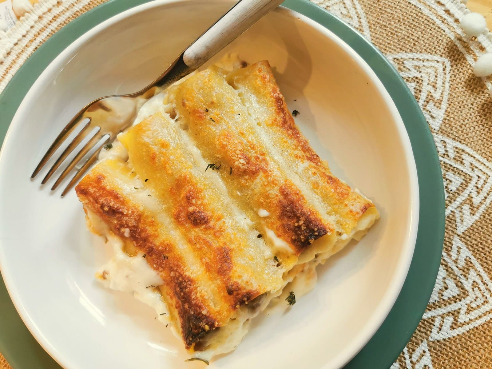 Easy beef cannelloni with béchamel in white bowl.
