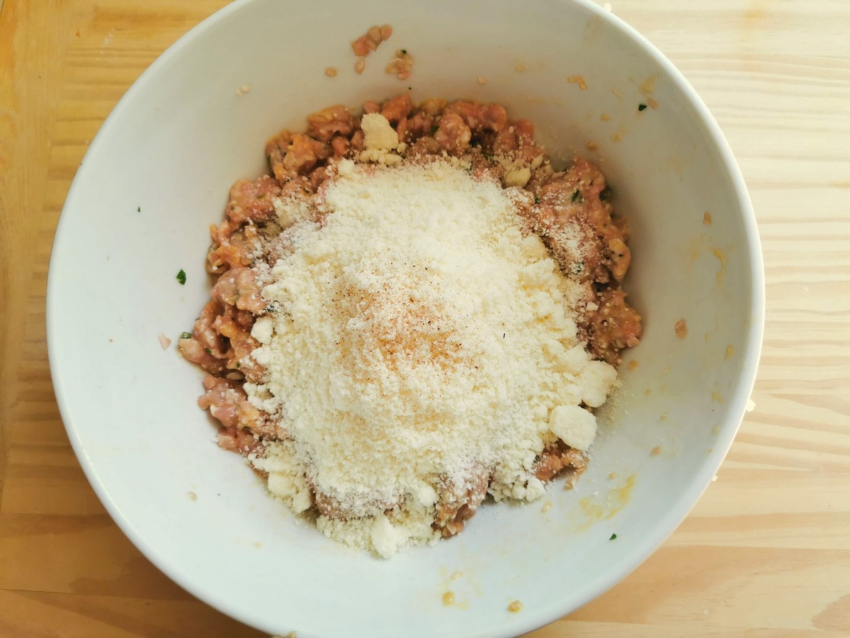 Grated pecorino and nutmeg added to ground veal and egg mixture in large bowl.