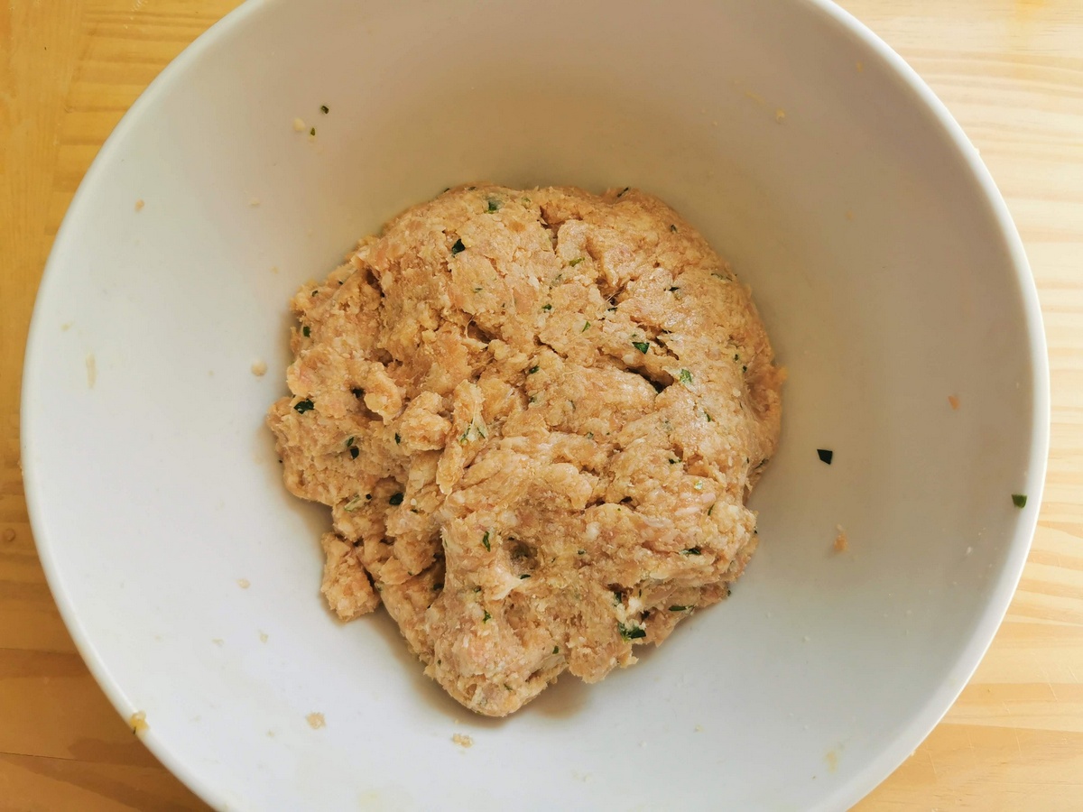 Ready veal meatball mixture in large bowl.