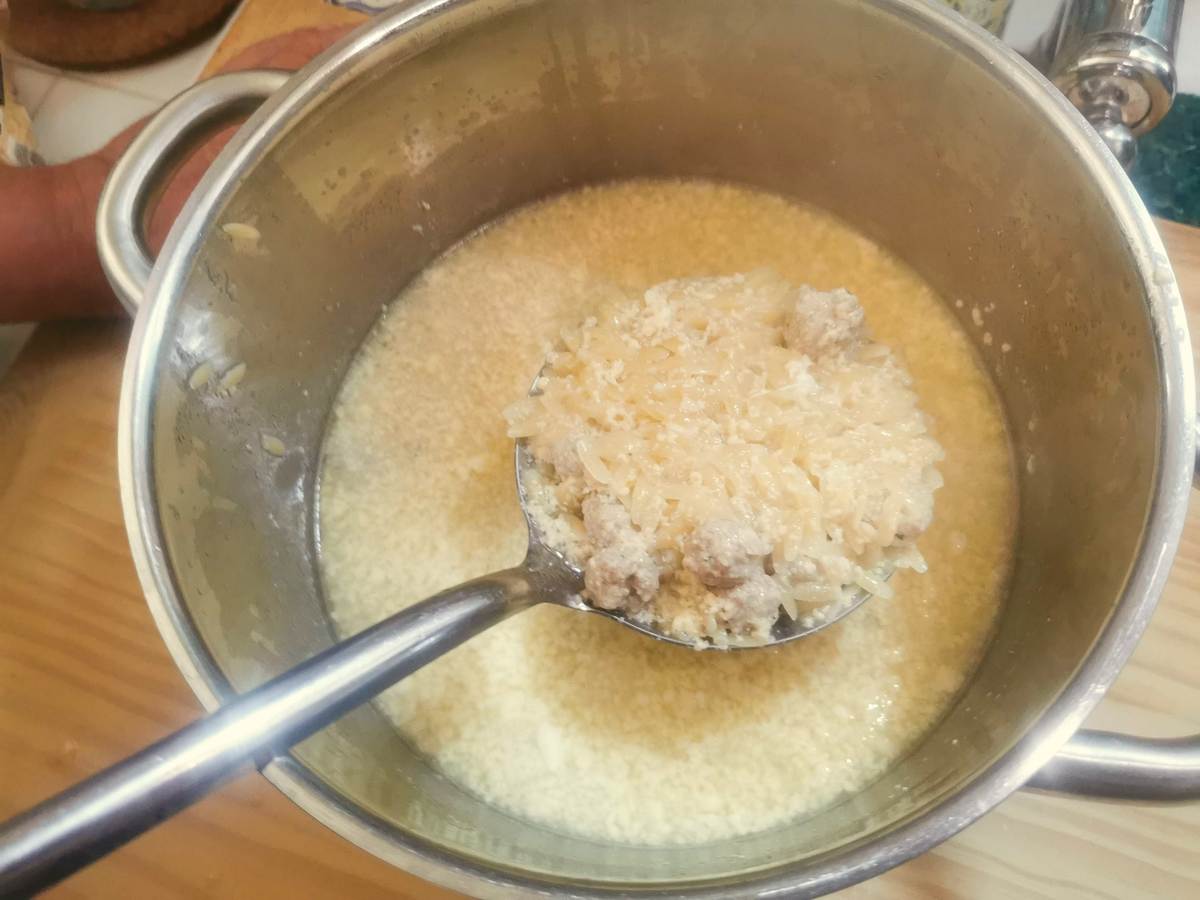 Sicilian meatball soup with egg and cheese mixture in large pot.