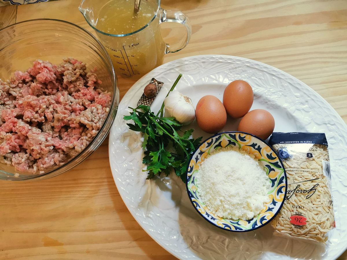 Ingredients for Sicilian meatball soup; ground veal, eggs, garlic, parsley, nutmeg, pecorino, orzo pasta and homemade beef broth.