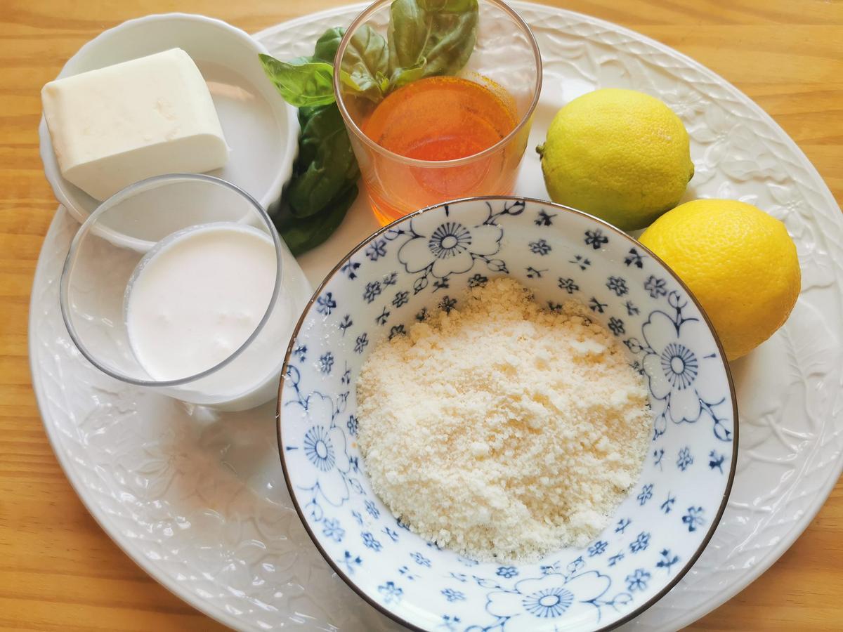 Ingredients for saffron, lemon, and butter pasta on white plate.
