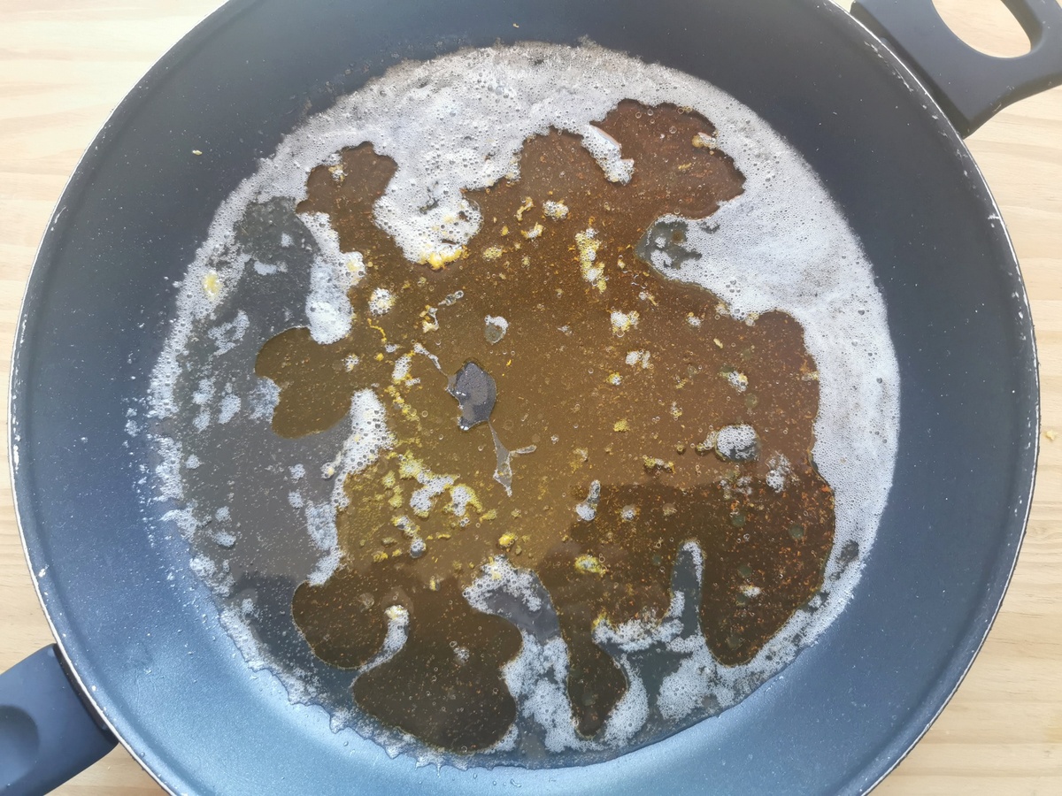 Saffron water added to butter and lemon zest in large skillet.