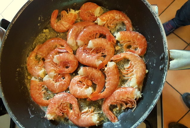 Prawns cooking in frying pan for fettuccine pasta with giant prawns 