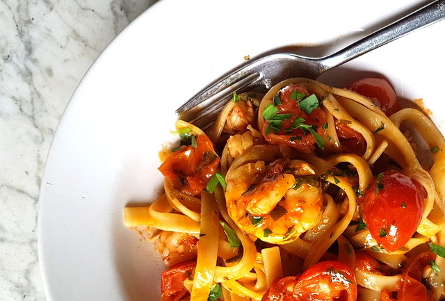 Fettuccine pasta with giant prawns and cherry tomatoes