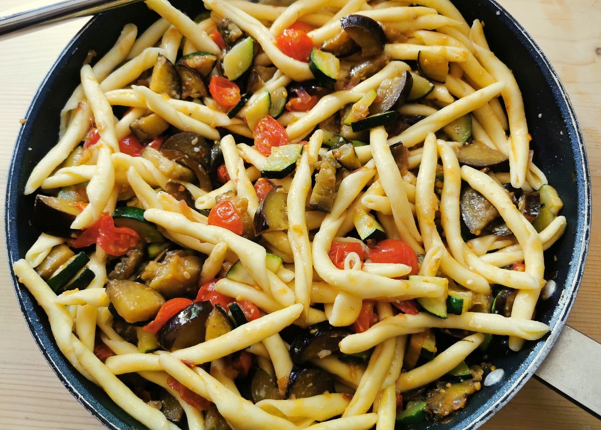 cooked fileja pasta added to sauce in skillet