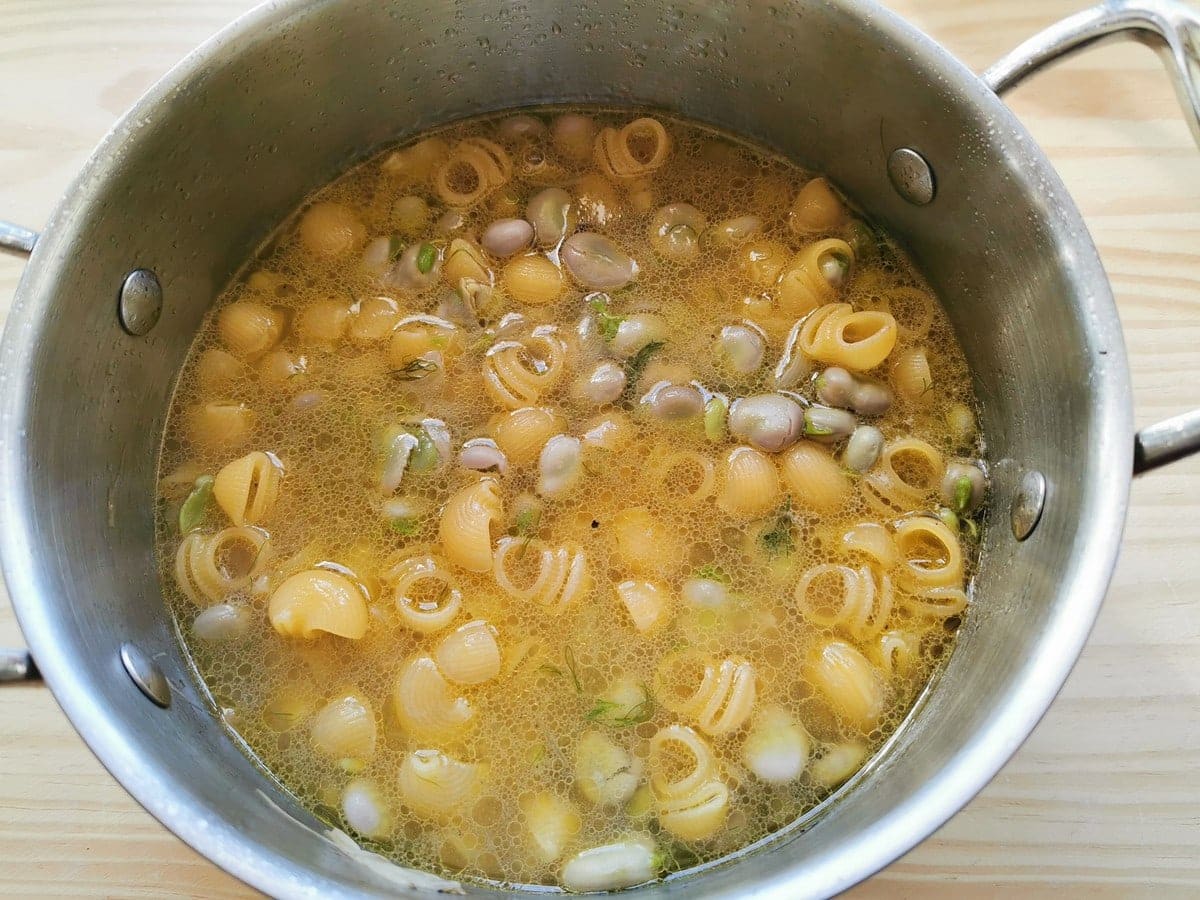 pasta cooking with fava beans in pot