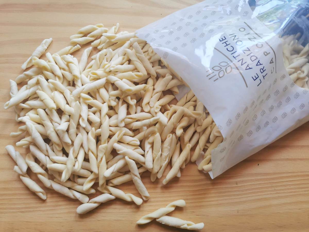 Store-bought fresh strozzapreti on wood worktop.