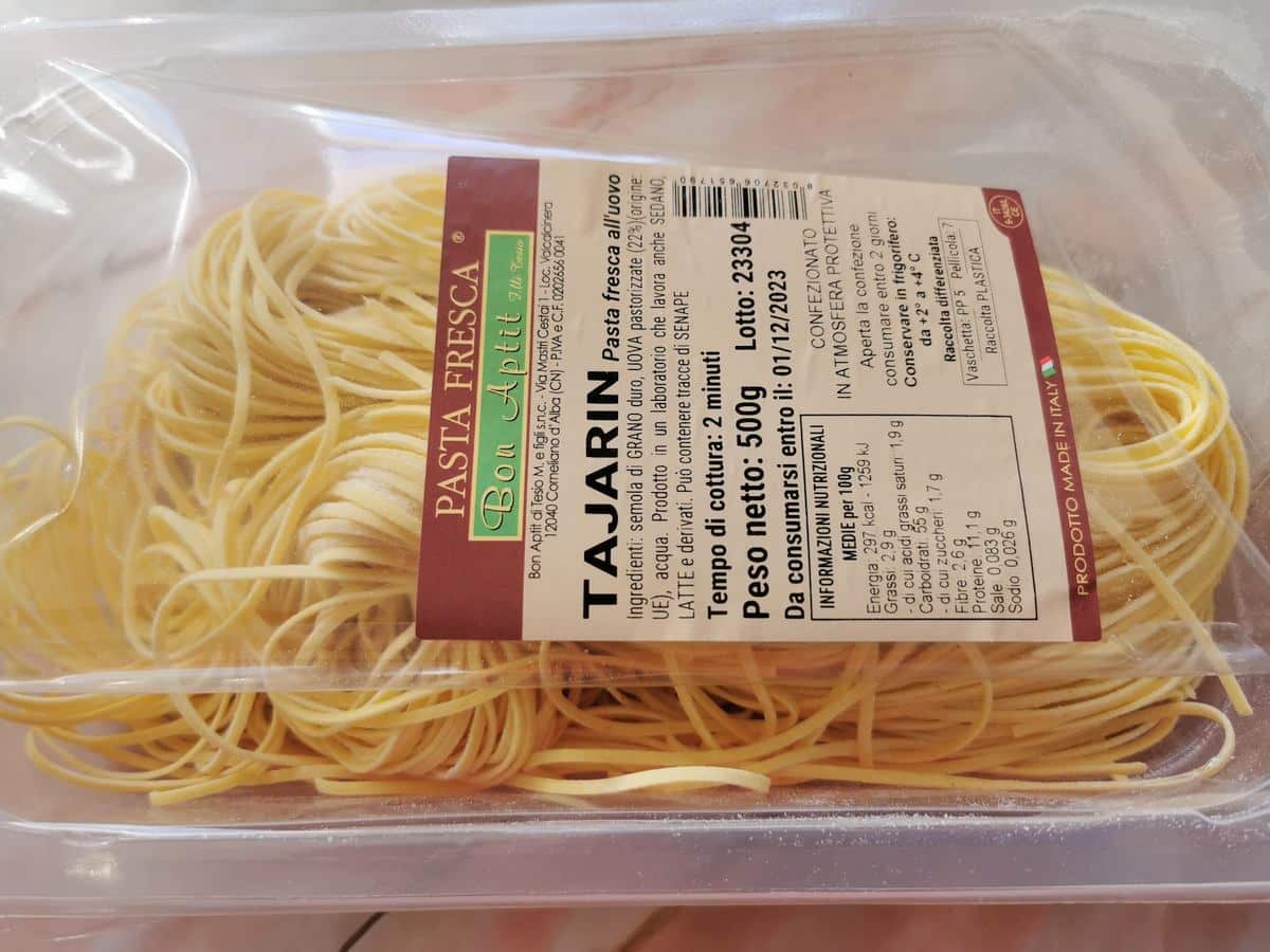 Fresh ready-made tajarin pasta in plastic container.