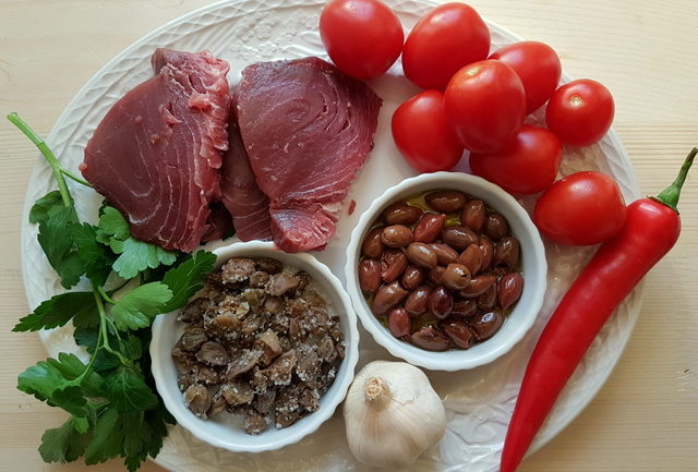 Ingredients for fresh tuna pasta all'eoliana on a white plate