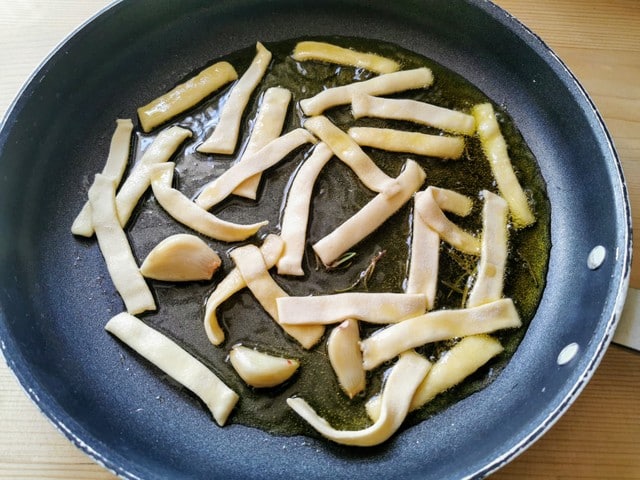 homemade sagne frying in olive oil with rosemary and garlic.