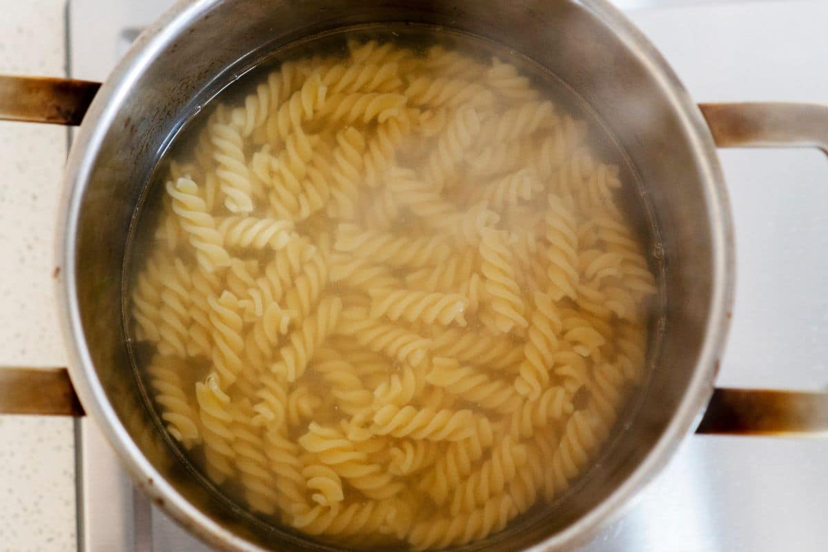 Cooked fusilli in a large pot of water.