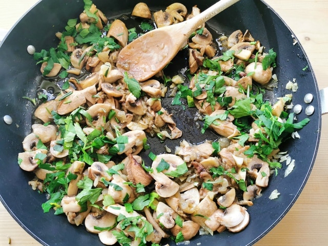 mushrooms, onions, parsley and the other herbs cooking in skillet