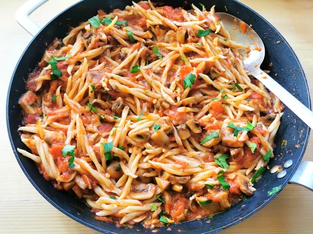 Genovese mushroom ragu with trofie pasta mixed together in skillet