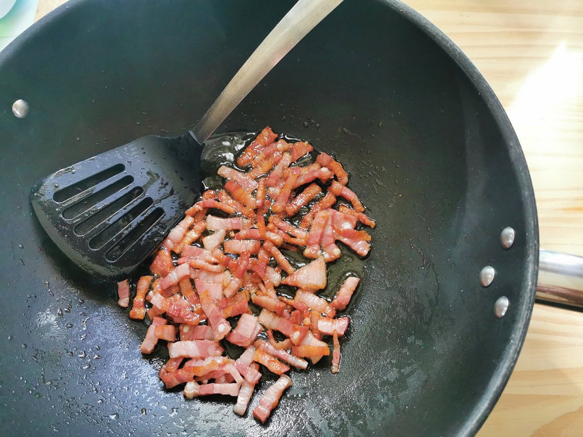 Crispy cooked pancetta in large skillet.