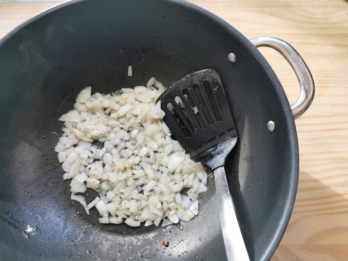 Diced onion in large skillet cooking in the pancetta fat.