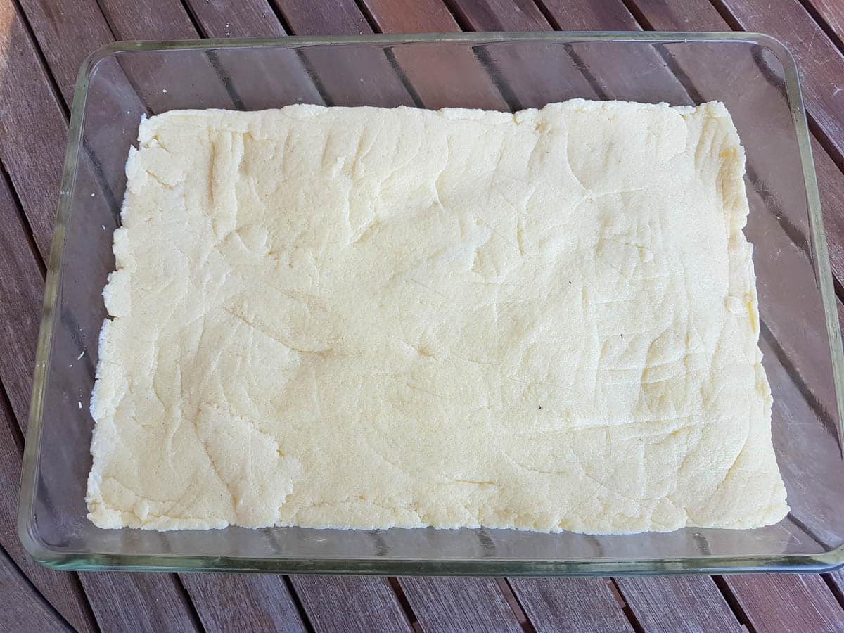 Gnocchi dough flattened in a baking dish