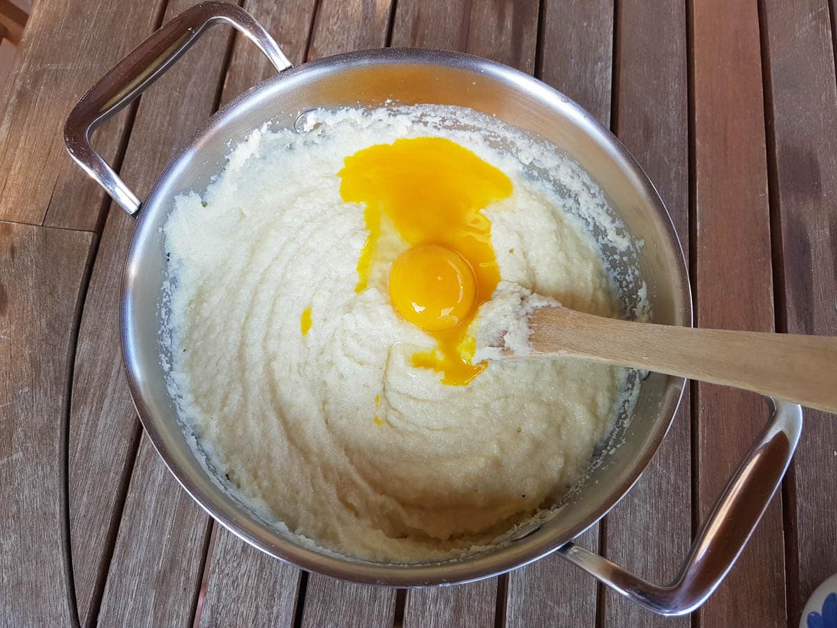 Adding the egg yolks to the semolina mixture