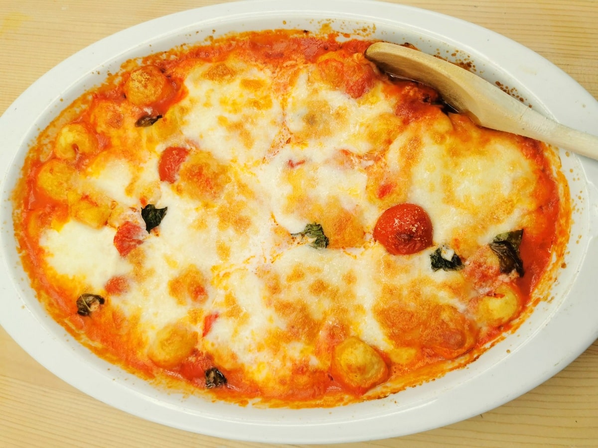 Bake gnocchi alla sorrentina on a kitchen counter.