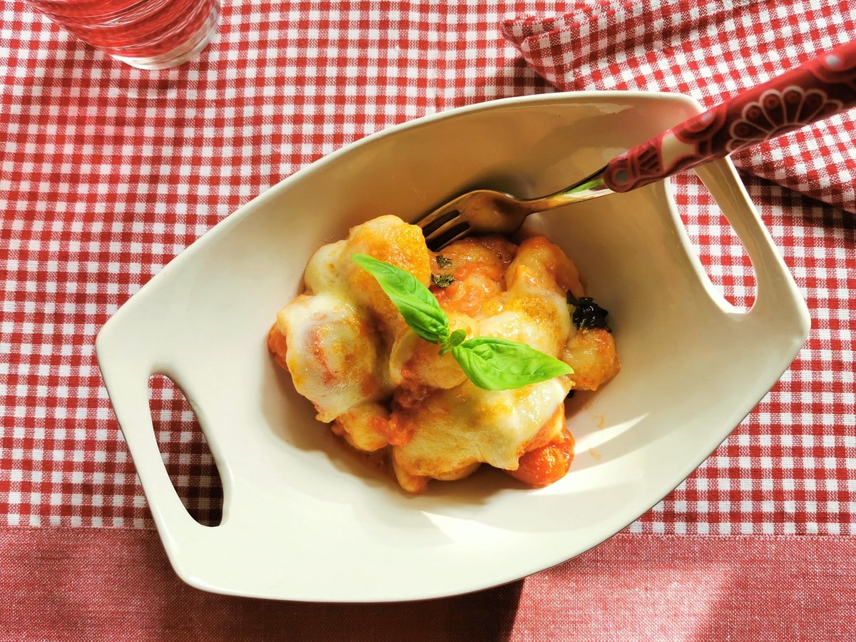 Baked gnocchi alla sorrentina in a bowl with basil.