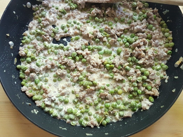 sausage, peas and cream sauce in skillet