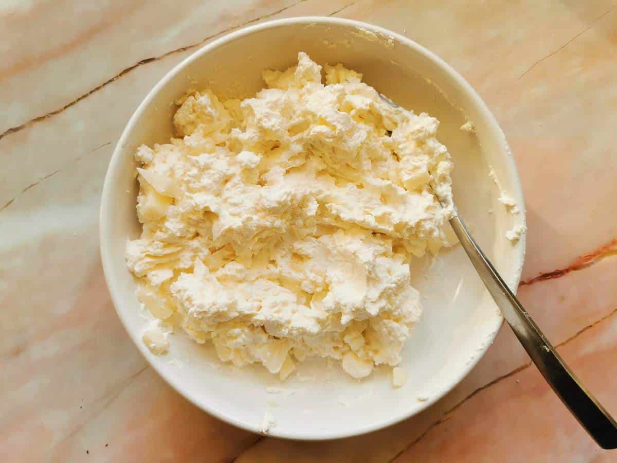 Ready ravioli filling in white bowl, made of ricotta, mascarpone, grated parmigiano and pears.