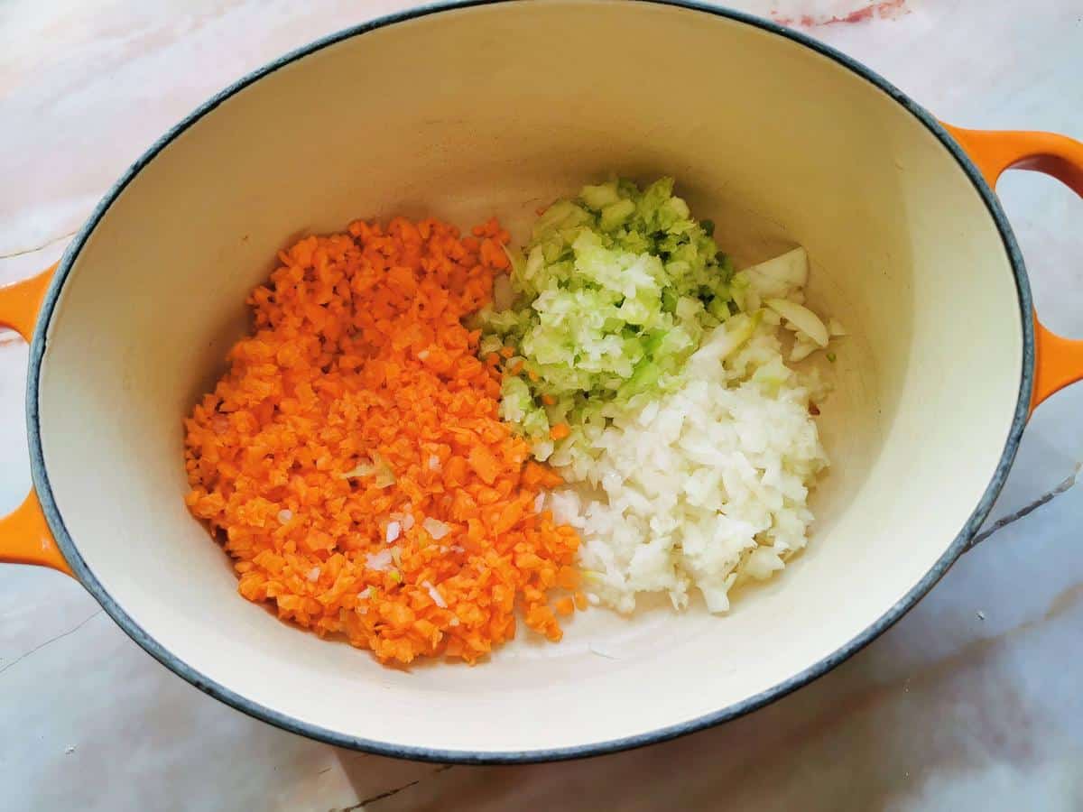 finely chopped onion, carrot and celery (soffrito) in Dutch oven.