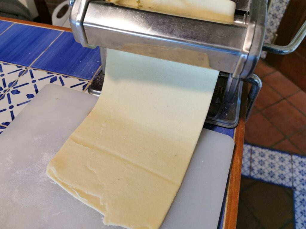 pasta sheet passing through pasta machine rollers