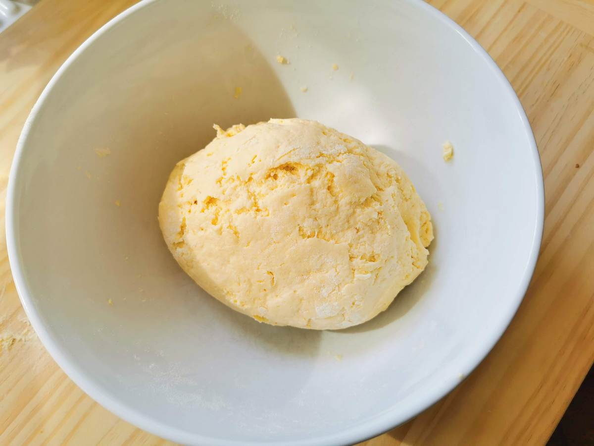 a ball of pasta dough in a white bowl.