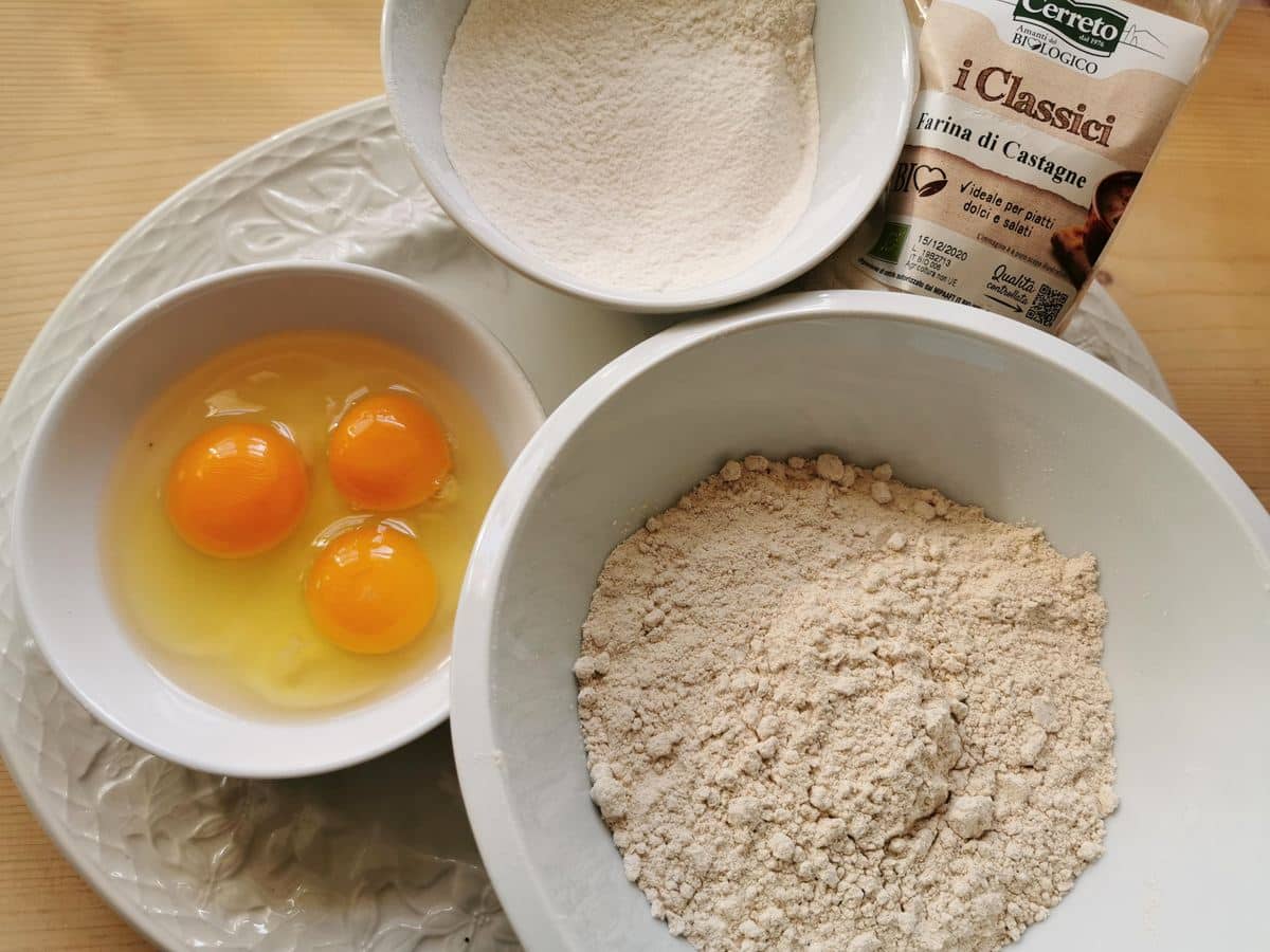 ingredients for homemade chestnut pasta on white plate