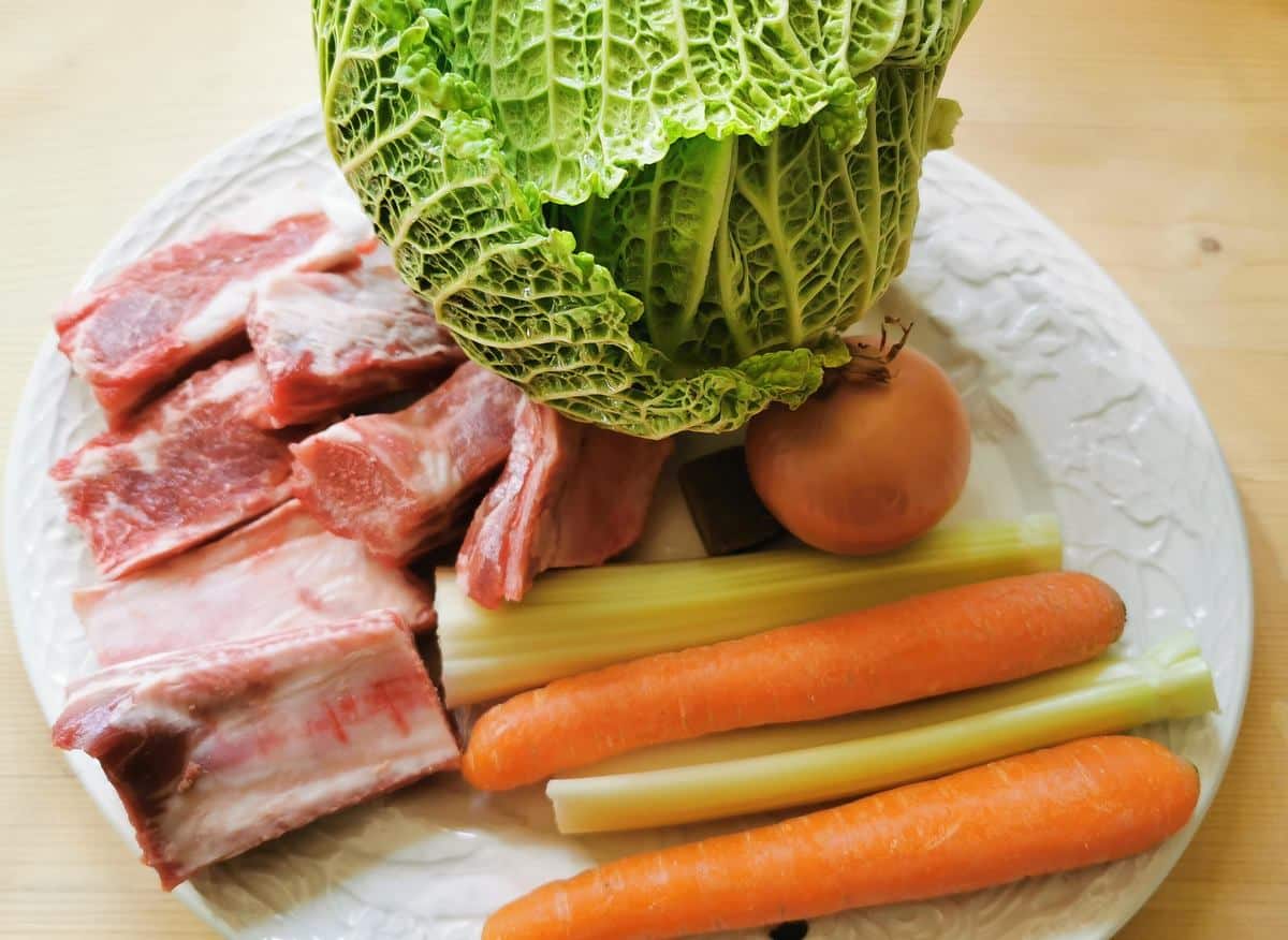 ingredients for pork and cabbage sauce on white plate