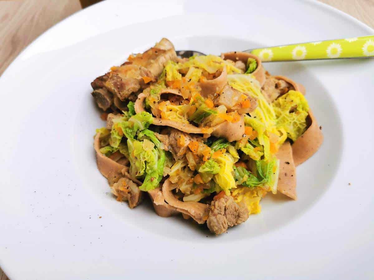 Homemade chestnut pasta with pork and cabbage.