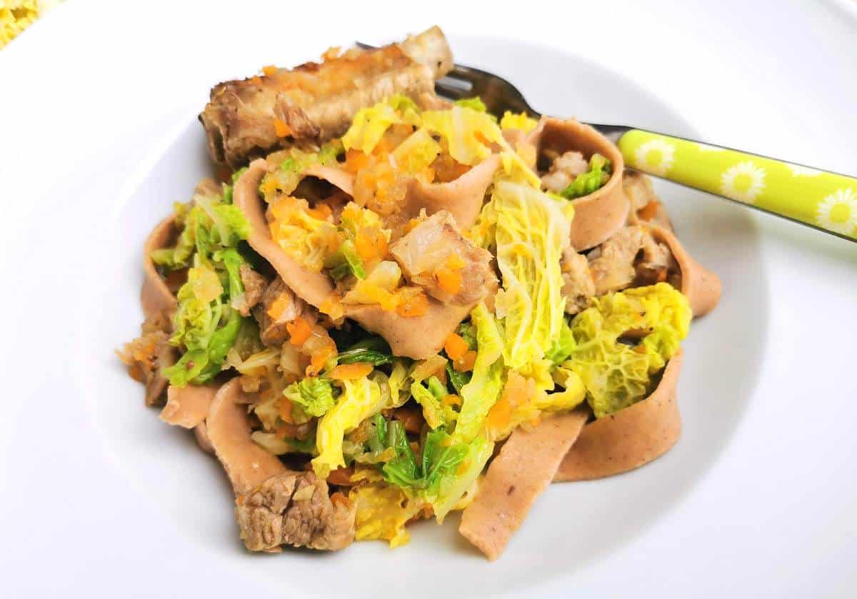 Homemade chestnut pasta with pork and cabbage.