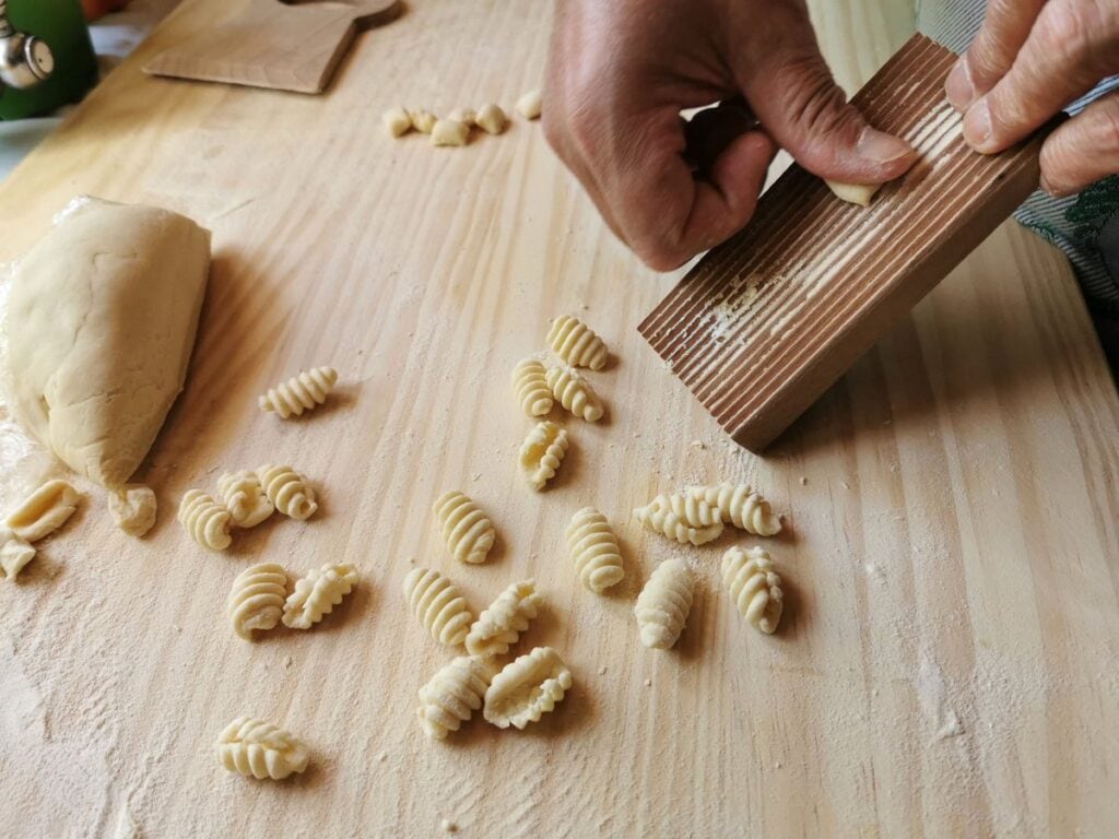 Making Sardinian gnocchi using a gnocchi board