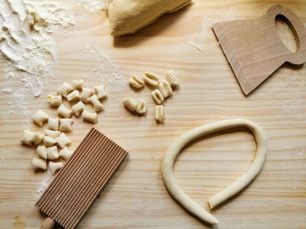 pasta rolled into a 'snake' with cut pieces of dough and ready Sardinian gnocchi