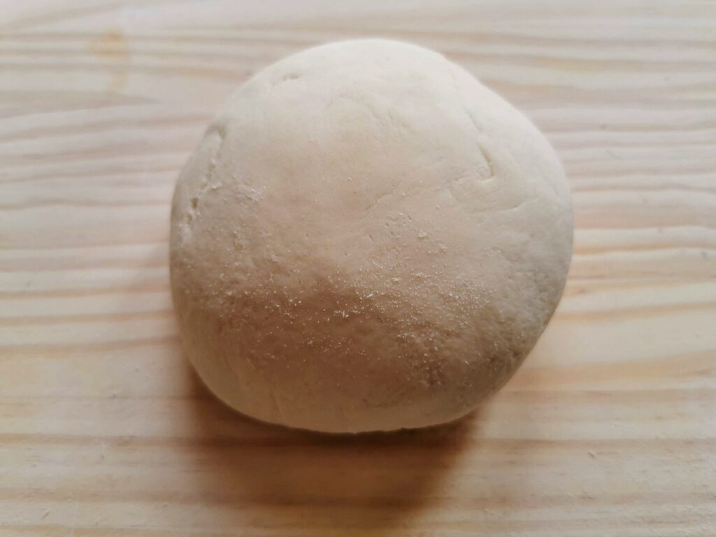ball of pasta dough on pastry board
