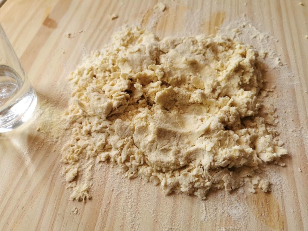 Semolina flour mixed with salted water on pastry board