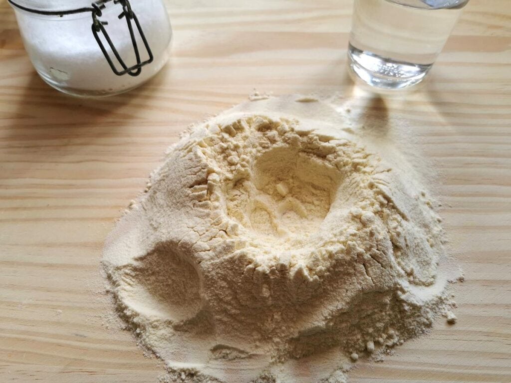 mound of semolina flour with well in the middle
