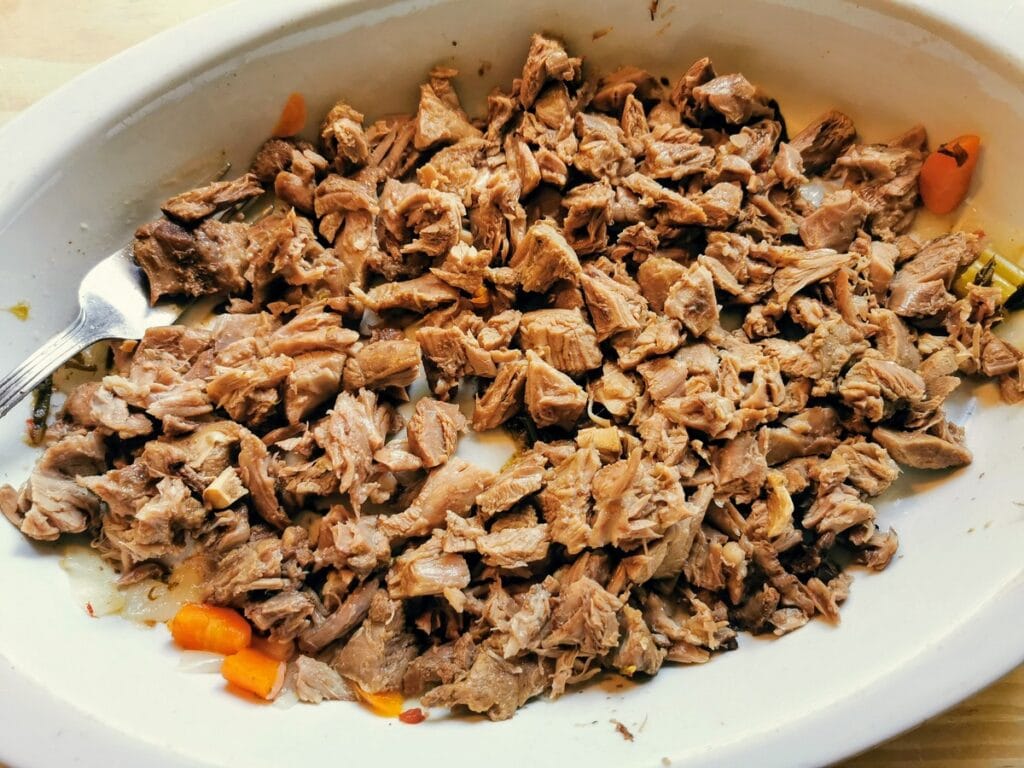 shredded lamb meat in white dish