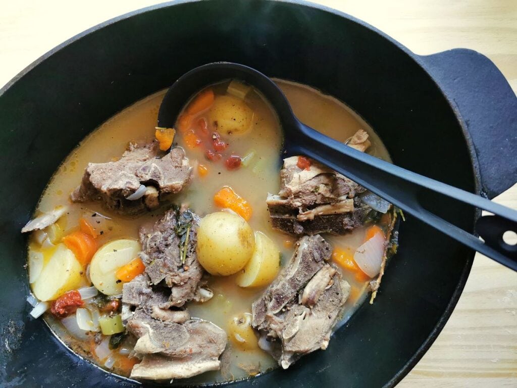 potatoes added to lamb broth in Dutch oven